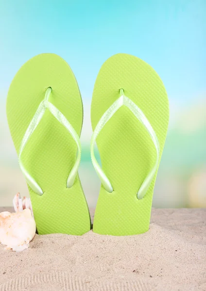 Bright flip-flops on sand, on nature background — Stock Photo, Image