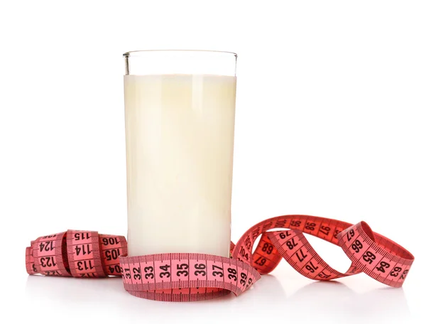 Glass of milk with measuring tape isolated on white — Stock Photo, Image