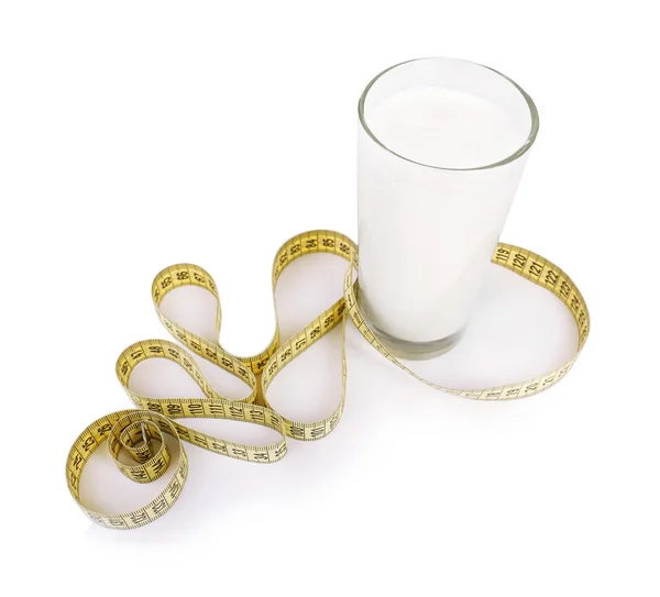 Glass of milk with measuring tape isolated on white — Stock Photo, Image