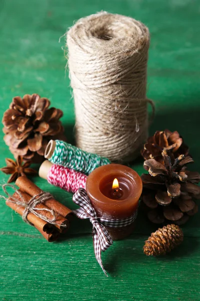 Composition with natural bump, candle, thread, cinnamon sticks — Stock Photo, Image