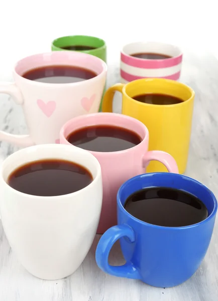 Muitas xícaras de café na mesa de madeira perto — Fotografia de Stock