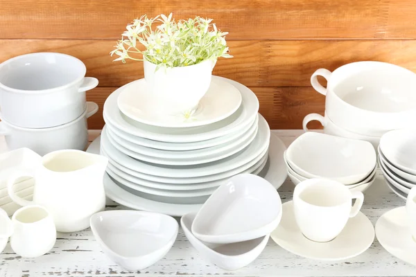 Different tableware on shelf, on wooden background — Stock Photo, Image