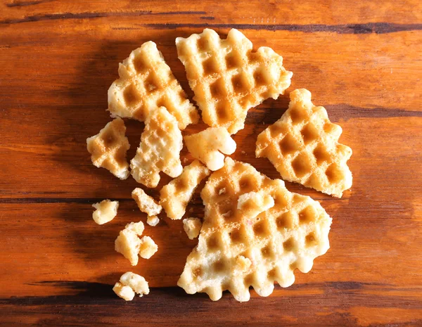 Crushed waffle on wooden background — Stock Photo, Image