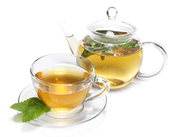 Composition of fresh mint tea in glass cup and teapot and brown sugar isolated on white — Stock Photo, Image
