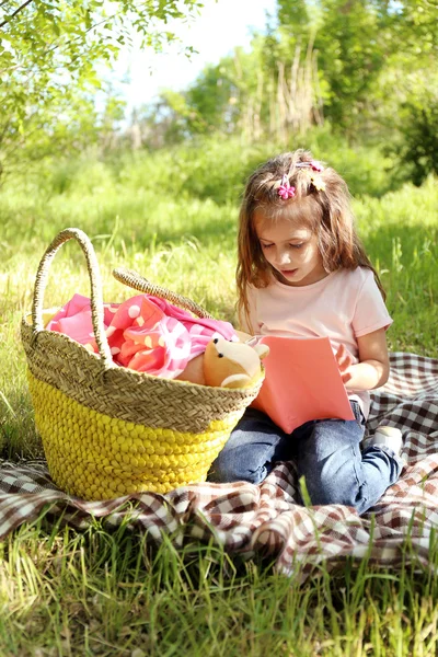 Счастливая маленькая девочка в зеленом парке — стоковое фото
