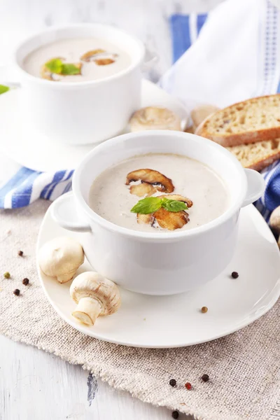 Mushroom soup in white pots, on napkin, on wooden background — Stock Image Mushroom soup in white pots, on napkin, on wooden background Stock Image