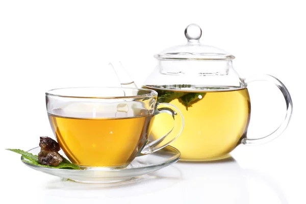 Composition of fresh mint tea in glass cup and teapot and brown sugar isolated on white — Stock Photo, Image