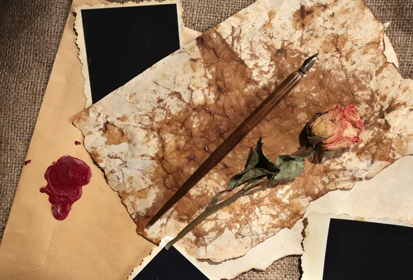 Composition with blank old photos, paper, letters on sackcloth background — Stock Photo, Image