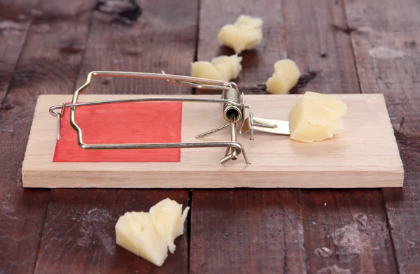 Trappola per topi con formaggio su sfondo di legno — Foto Stock