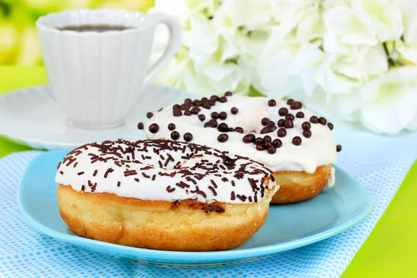 Sweet donuts with cup of tea on table close-up — Stock Photo, Image