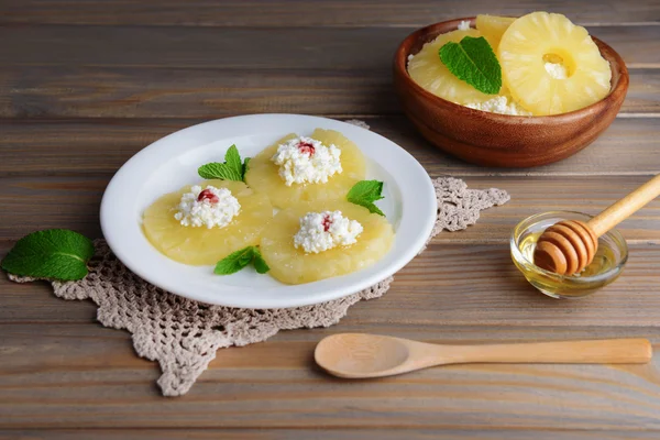 Tasty pineapple with cottage cheese on  wooden table — Stock Photo, Image
