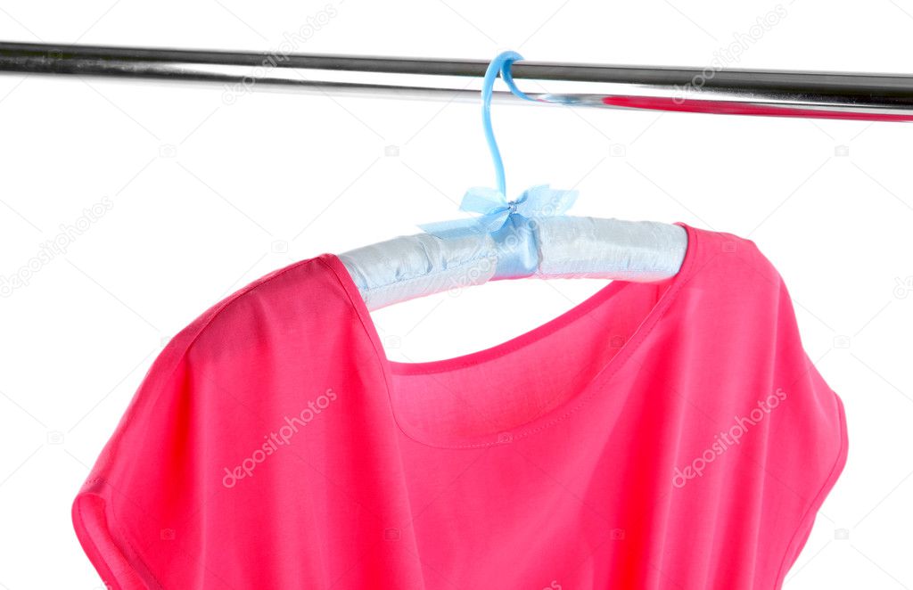 Beautiful pink dress hanging on hangers isolated on white