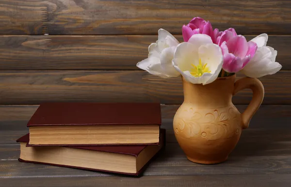 Tulipas bonitas em balde em jarro na mesa em fundo cinza — Fotografia de Stock