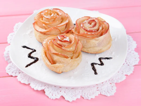 Välsmakande smördeg med apple formade rosor på tallriken på bordet närbild — Stockfoto