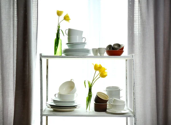 Different tableware on shelf in the interior — Stock Photo, Image