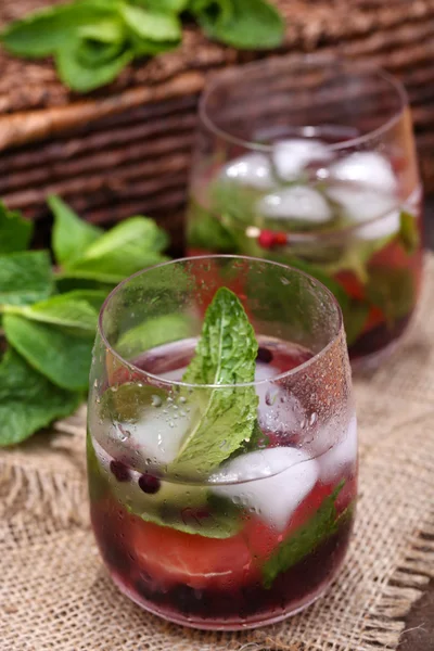 Tasty cocktail with fresh grapefruit and mint leaves on wooden table background — Stock Photo, Image