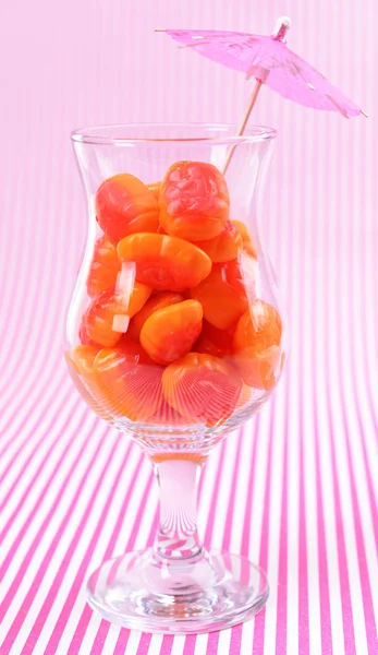 Different colorful fruit candy in glass on pink background — Stock Photo, Image