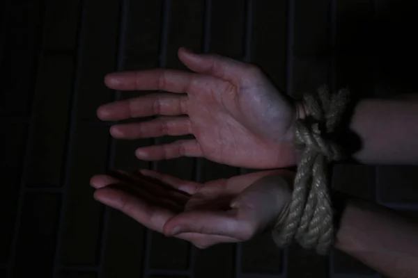 Tied hands on dark background — Stock Photo, Image