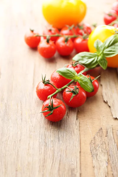 Fresh cherry tomatoes on old wooden table — Stock Photo, Image