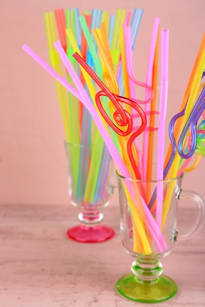 Straws in glasses on pink background — Stock Photo, Image