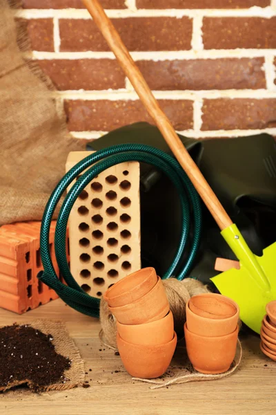 Tools of gardener on  bricks background — Stock Photo, Image