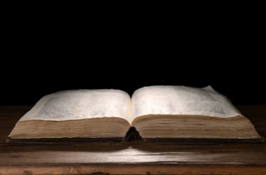 siyah arka plan üzerine masada eski kitap