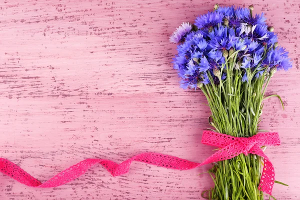 Beautiful bouquet with lace ribbon on wooden background — Stock Photo, Image