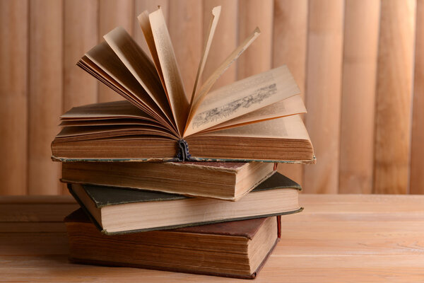 Old books on table on wooden background