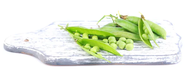 Fresh green peas on wooden board isolated on white background — Stock Photo, Image