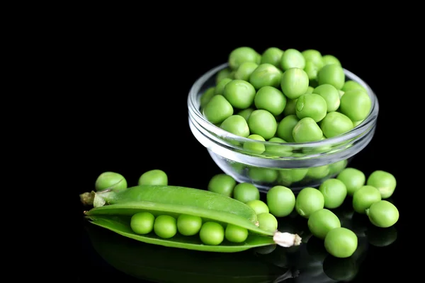 Fresh green peas in bowl isolated on black background — Stock Photo, Image