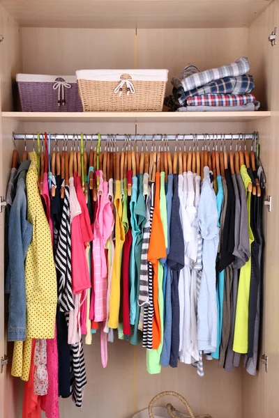 Красочная одежда висит в шкафу — стоковое фото