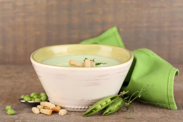 Tasty peas soup on wooden table — Stock Photo, Image