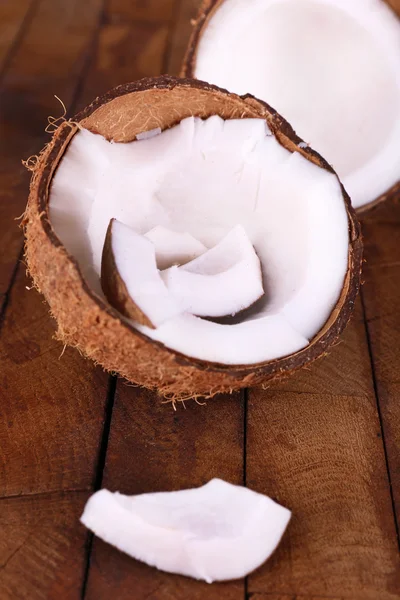 Broken coconut on wooden background — Stock Photo, Image