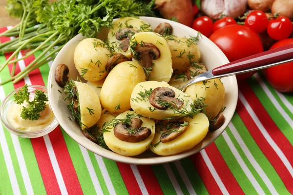 Young boiled potatoes with mushrooms on table, close up — Stock Photo, Image