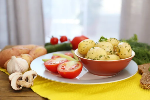 Young boiled potatoes on table on window background — Stock Photo, Image