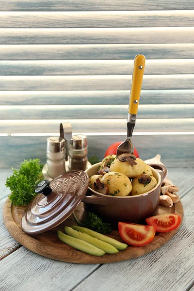 Patatas jóvenes hervidas en sartén con verduras sobre mesa de madera —  Fotos de Stock