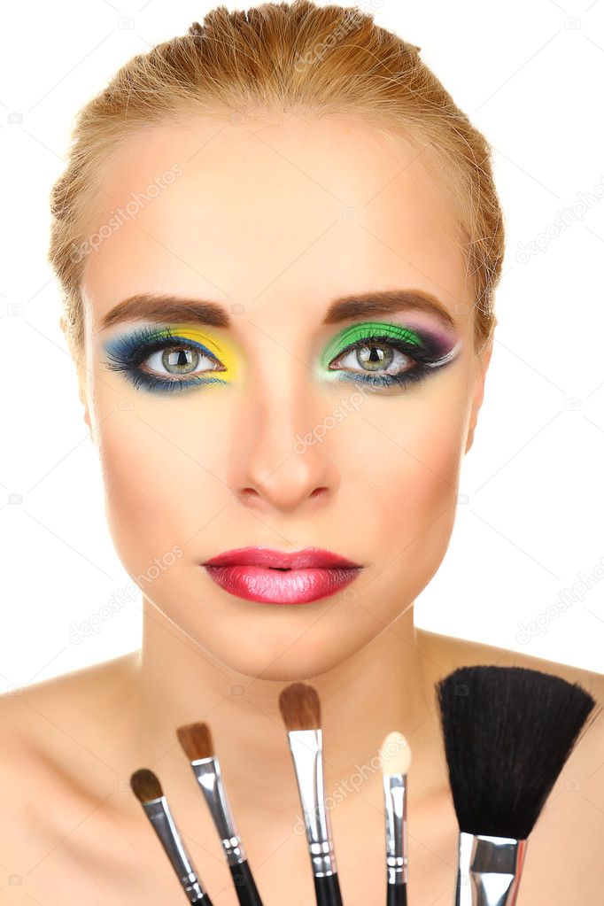 Beautiful woman with bright make-up and brushes, isolated on white