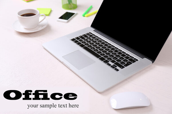 Office workplace with open laptop on wooden desk