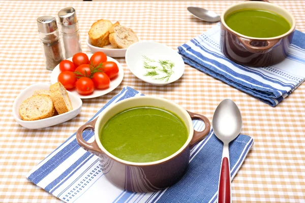 Tasty soup in saucepans on tablecloth, close up — Stock Photo, Image