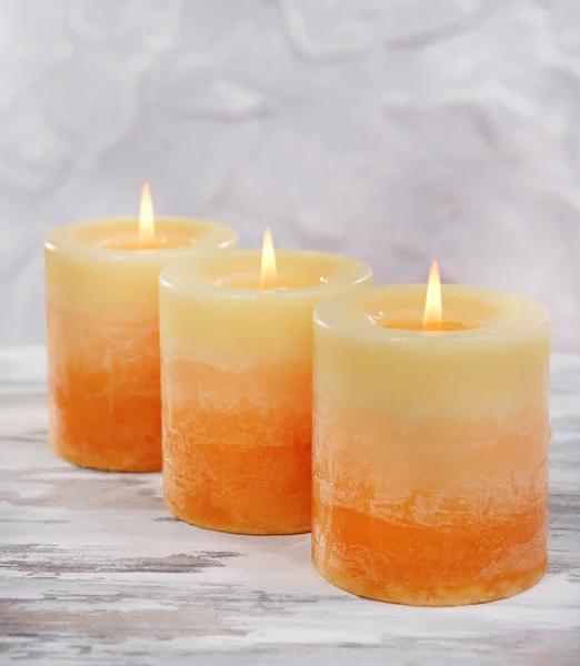 Beautiful candles on table on grey background — Stock Photo, Image