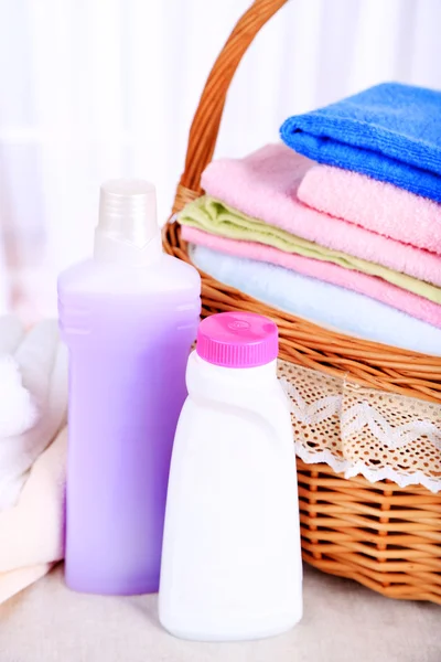 Colorful towels in basket on light background — Stock Photo, Image