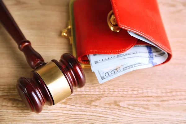 Gavel e dinheiro em carteira em fundo de madeira — Fotografia de Stock