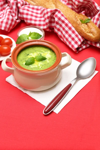 Tasty soup in saucepan on tablecloth, close up — Stock Photo, Image