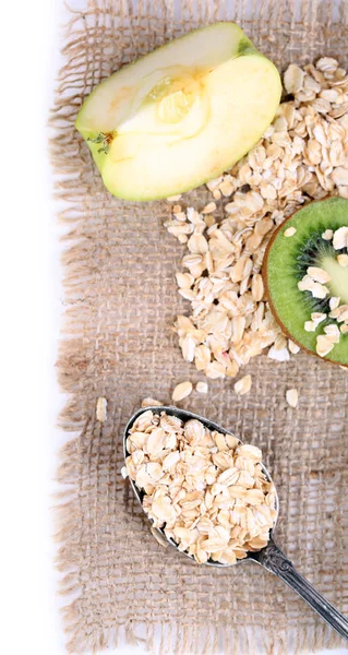 Apple, kiwi fruit with oatmeal and vintage spoon isolated on white — Stock Photo, Image