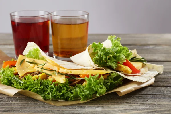 Veggie wrap filled with cheese and fresh vegetables on table — Stock Photo, Image