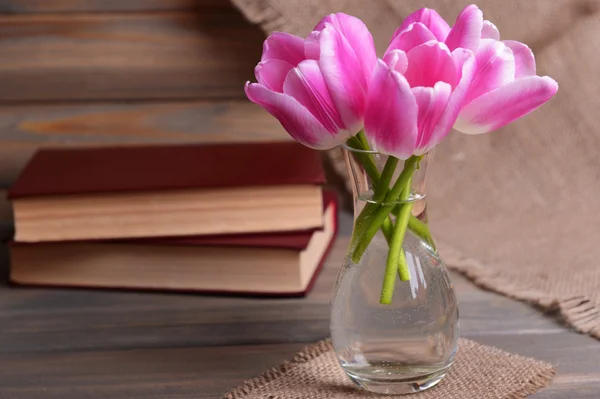 Beautiful tulips in bucket in vase on table on grey background — Stock Photo, Image