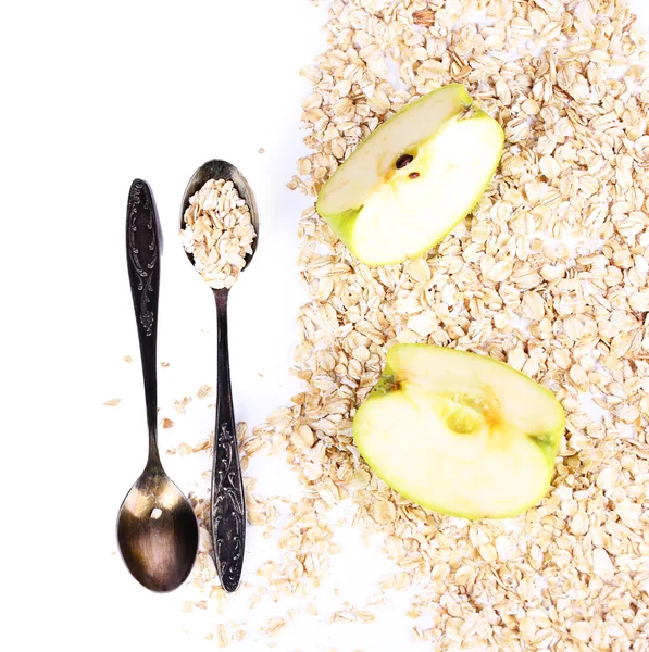 Apple with oatmeal and vintage spoons, isolated on white — Stock Photo, Image