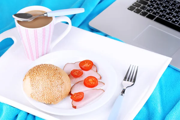 Composition with laptop and tasty breakfast on wooden tray, close-up — Stock Photo, Image