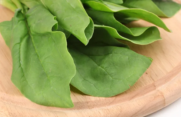 Fresh spinach on wooden board isolated on white — Stock Photo, Image