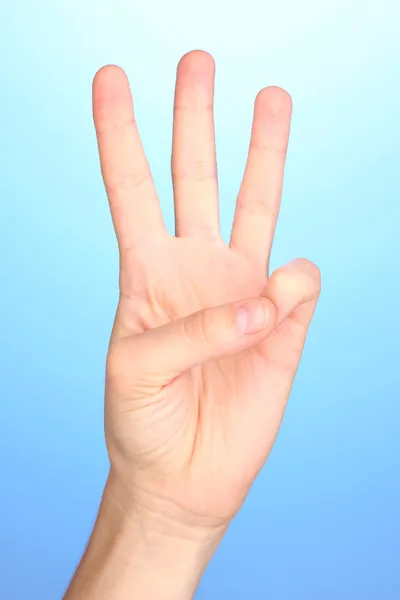 Hand making sign on blue background — Stock Photo, Image